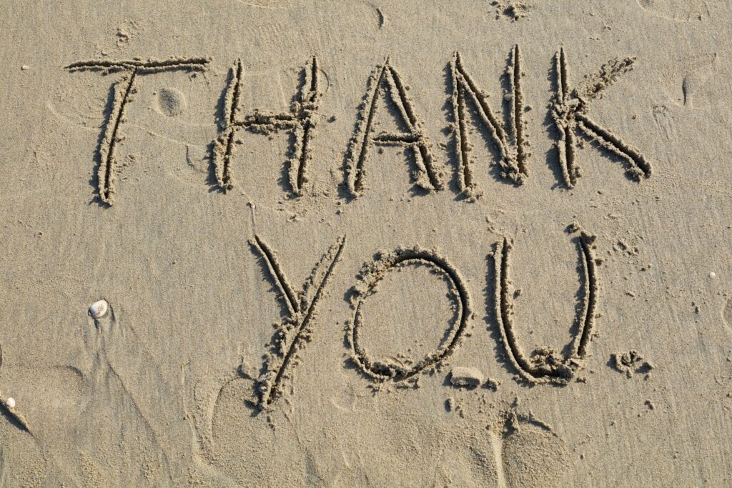 Thank you written in sand