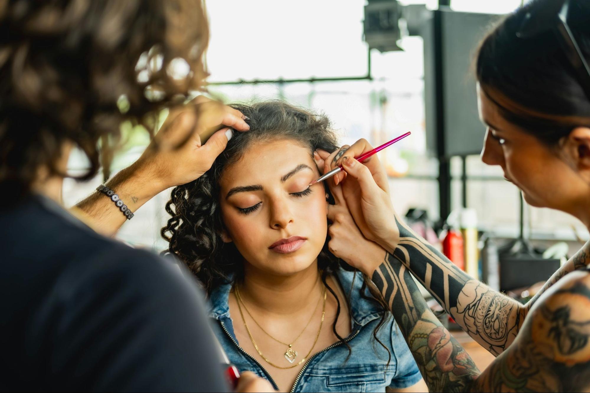 makeup stylist applying eye shadow