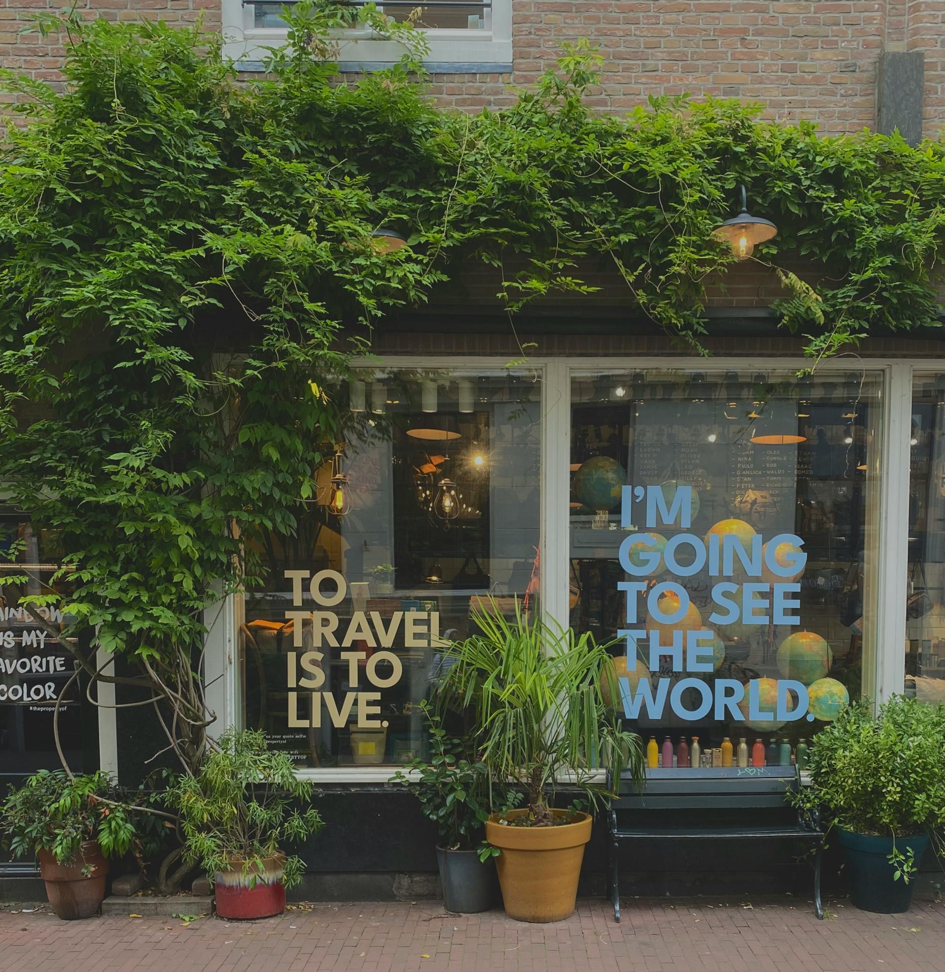 travel quotes on glass with shrubs overgrowing